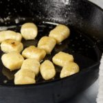 gnocchi cooking in cast iron pan