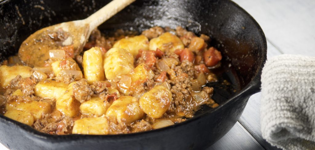 gnocchi, meat and tomatoes cooking