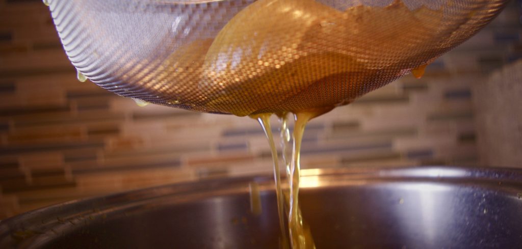 Liquid Stock Straining through sieve