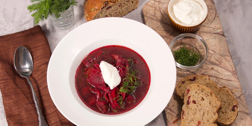 Bowl of Borscht with Dill, Sour Cream and Bread