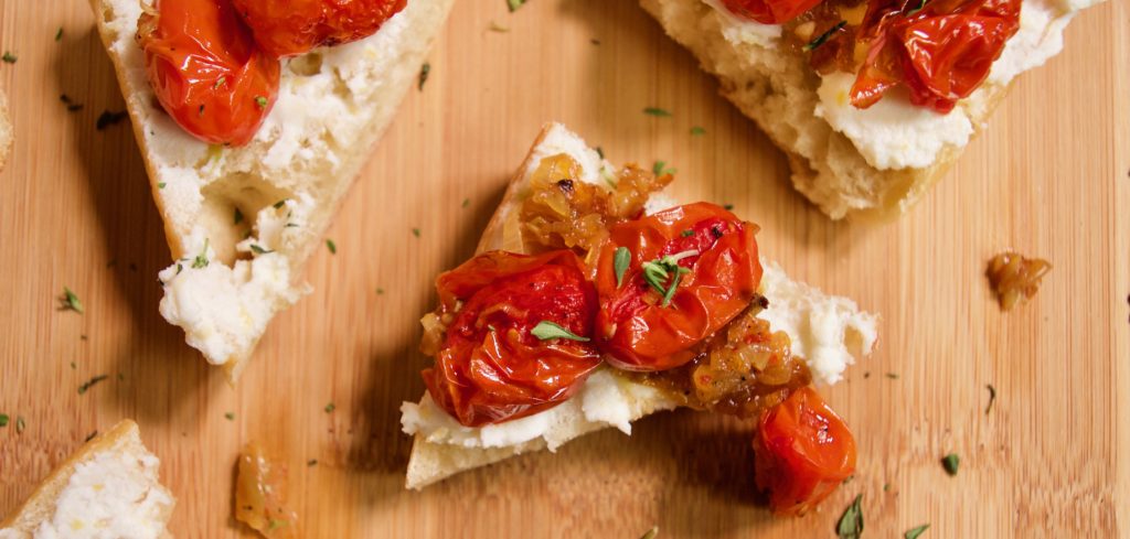 Roasted Tomatoes, Shallots, and garlic with Honey and Goat Cheese on Baguette