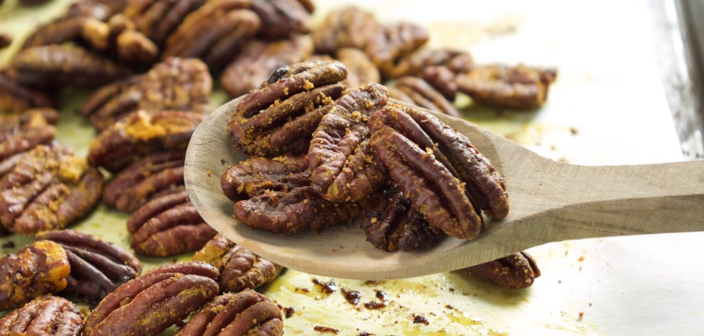 candied pecans with turmeric on baking tray