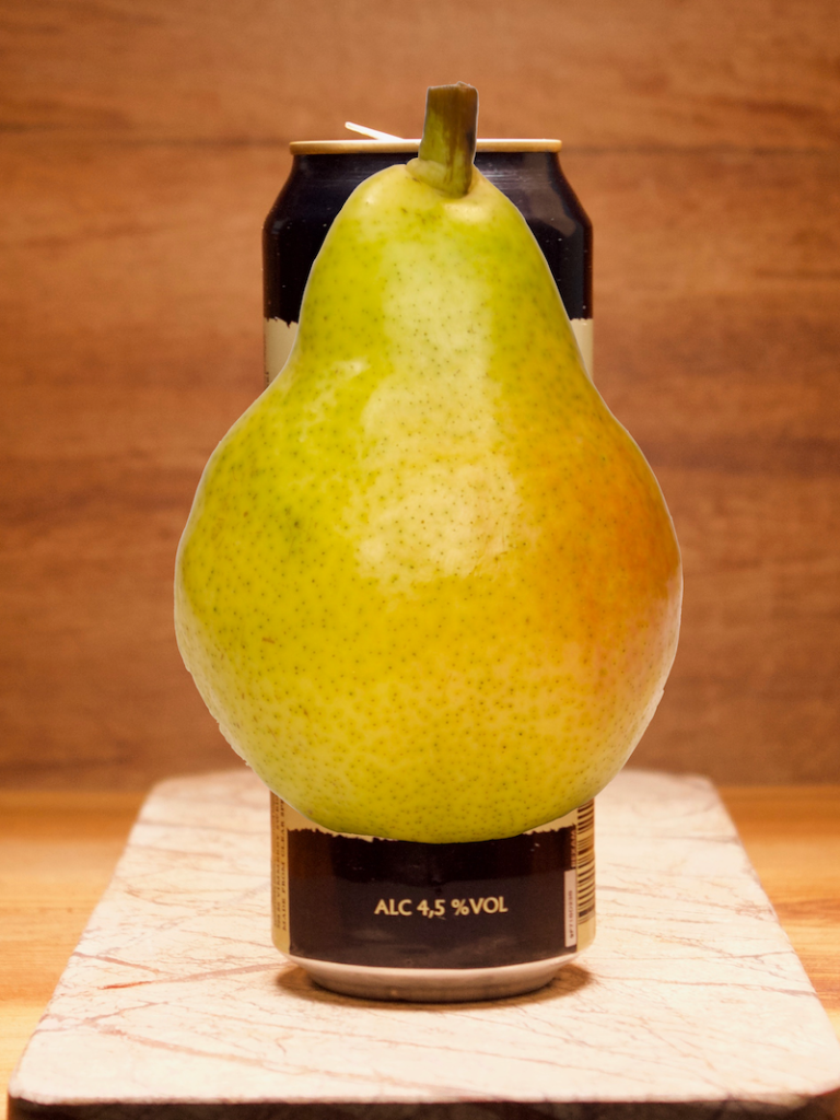 A Pear covering a Cider can