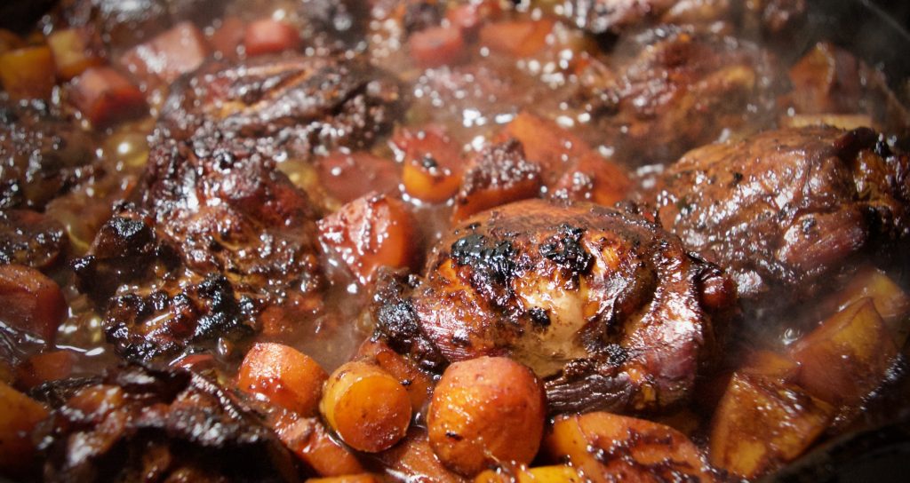 Chicken Adobo stewing in sauce with Carrots and Potato