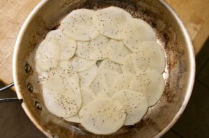 Anna potato layered in a fry pan