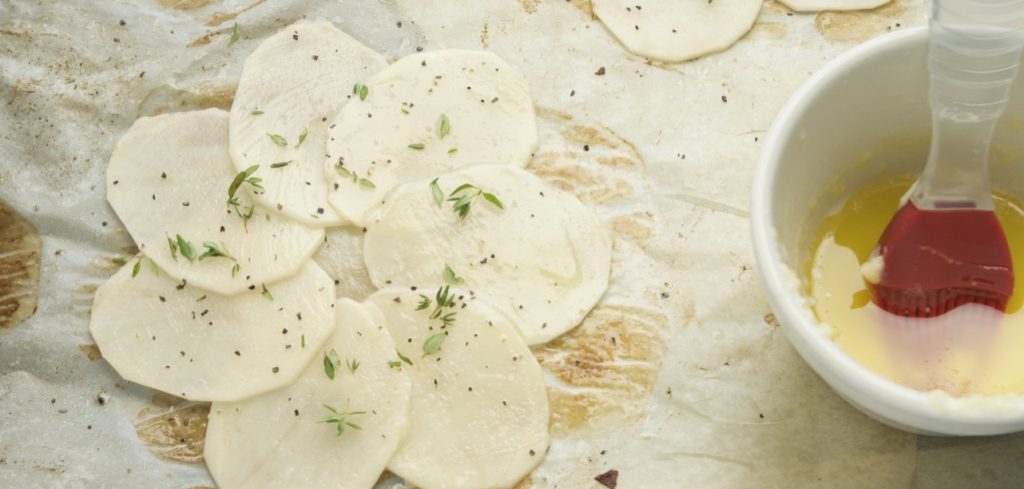 Sliced Potatoes for Anna Potato on a sheet pan