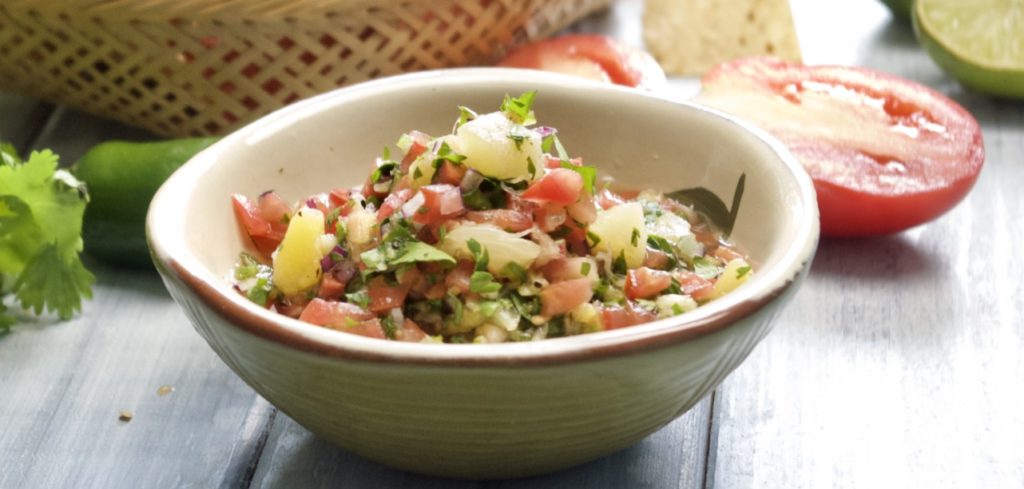 pineapple salsa in a bowl with chips
