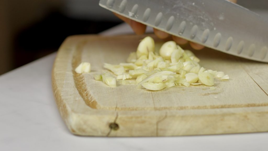 Chopped Garlic on cutting board.