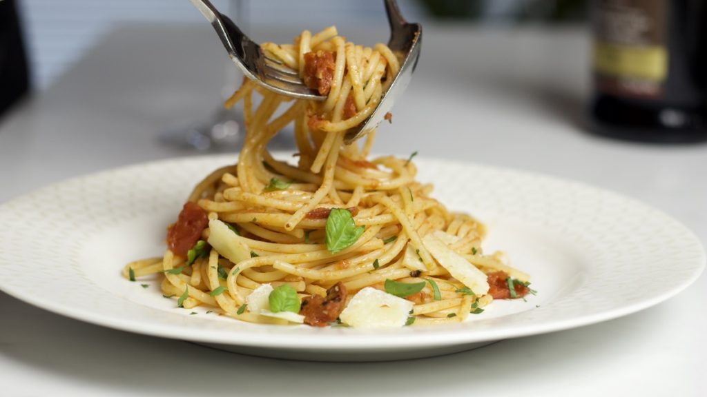 Spaghetti and Tomato Sauce twirled with fork and spoon.